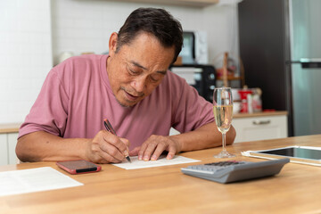 Portrait of handsome man sit on sofa arm on chin look interested notebook write down notes list to do indoors. Close Up of a senior man writing a letter.