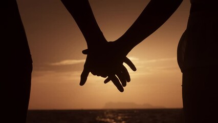 Close up silhouette man and woman touching hands together at sunset beach. Romantic couple couple holding each other hand's enjoying romantic date. Love couple holding hands on sea sunset background. - Powered by Adobe