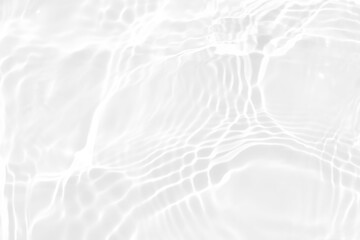 White water with ripples on the surface. Defocus blurred transparent white colored clear calm water surface texture with splashes and bubbles. Water waves with shining pattern texture background.