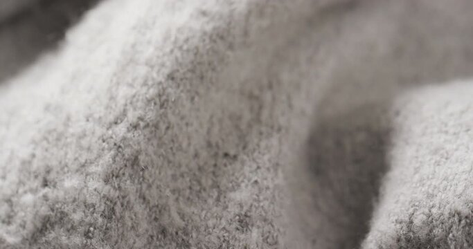 Micro video of close up of grey wooly fabric with copy space