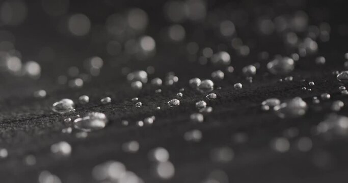 Micro video of close up of water drops with copy space on grey background