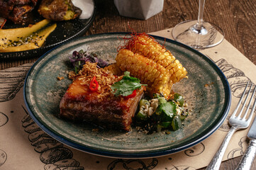 grilled marbled beef steak on a plate with vegetables and sauce