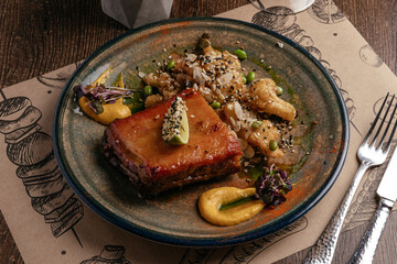 grilled marbled beef steak on a plate with vegetables and sauce