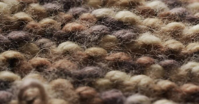 Micro video of close up of brown wooly crochet fabric with copy space