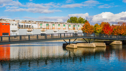 Bridge and warehouse, with bright maple trees, in Montreal, Canada.