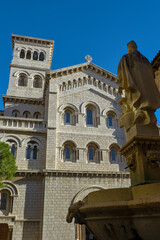 Saint Nicholas Cathedral in Monaco from a side with statue in foreground