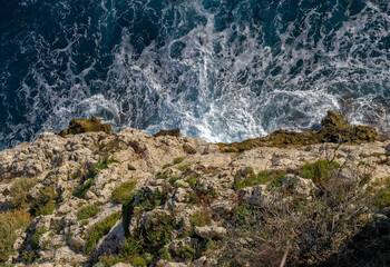 Obraz premium View on breaking waves down from cliff