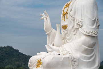 Close up hand of large statue of Guanyin showing Abhaya Mudra gesture. Abhaya mudra mean dispelling...
