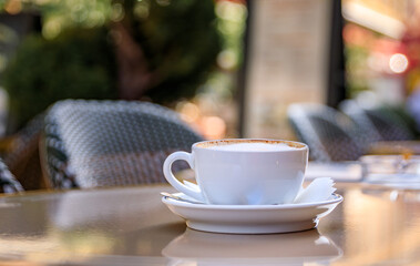 Cup of cappuccino cafe au lait coffee at breakfast on an outdoor table at a bakery cafe in the old town or Vieille Ville in Nice, French Riviera, South of France
