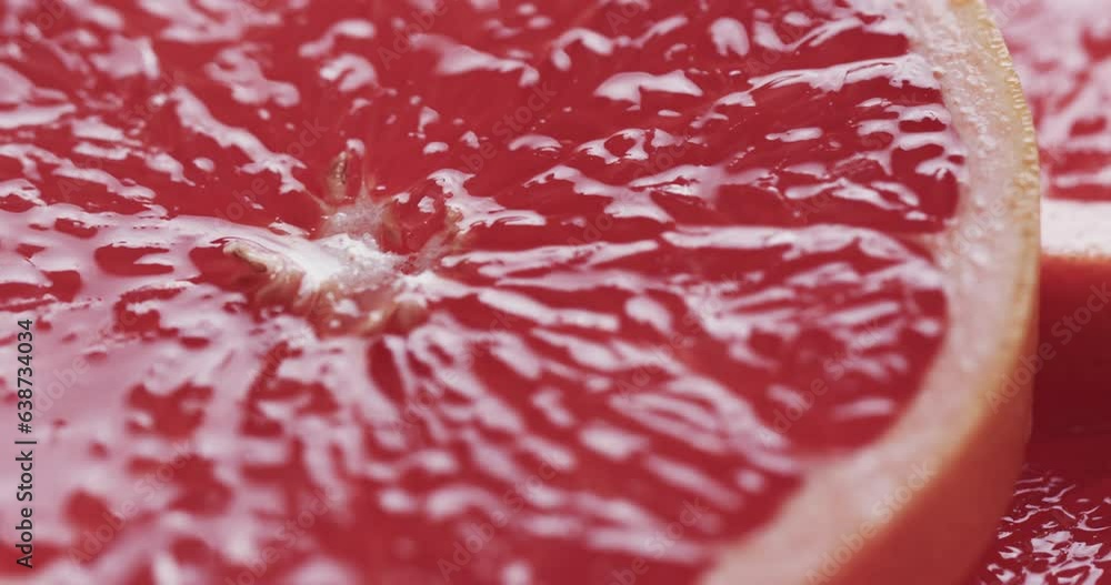 Poster micro video of close up of slices of red grapefruit with copy space