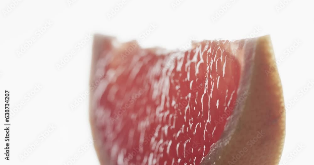 Poster micro video of close up of slice of red grapefruit with copy space on white background