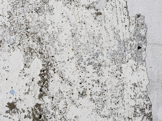 Vintage wall texture. The weathered, rough surface of a plastered concrete wall with faded, peeling paint. Perfect for background and design. Closeup.