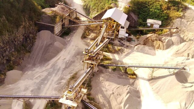 Industrial Extraction and Manufacturing Footage. Aerial video of a gravel pit and conveyor belts for stone distribution. Active mining facility located on Mount Pangradinan. High Quality 4k Video 