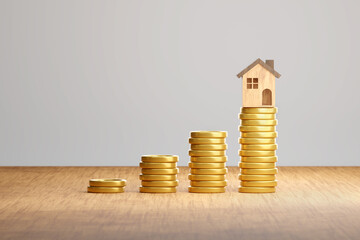 Stack of gold coins and wooden house on tabel with gray background for House loan interest and property business, 3D rendering.