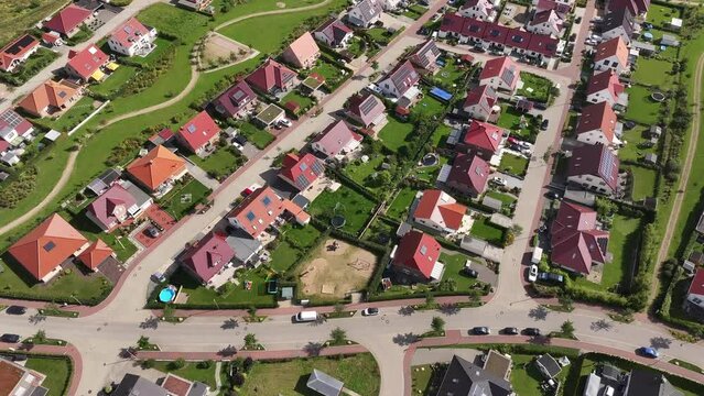 Residential area with many single family houses with green gardens in a small town, sunny day, drone, outskirts of the city