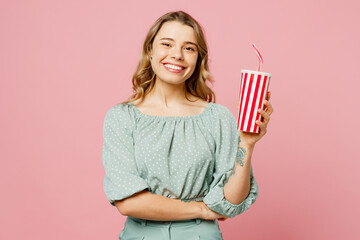 Young smiling cheerful happy woman she wear casual clothes look camera hold in hand cup of soda pop...