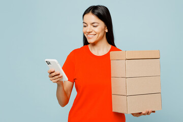 Young fun latin woman she wear orange red t-shirt casual clothes hold stack cardboard blank boxes...
