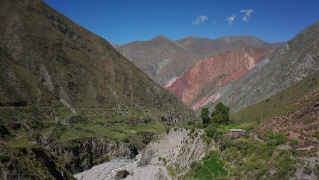 Rising aerial of green mountains at scenic Iruya in sunny Argentina