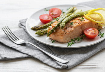 Baked Delicious salmon, green asparagus on  plate