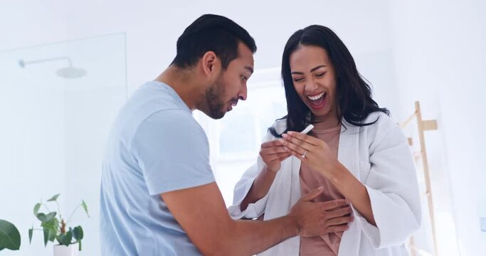 Smile, excited and couple with positive pregnancy test in the bathroom for celebration together. Happy, love and young man with support for pregnant woman with a fertility stick device in modern home