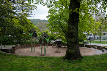 Obraz premium Child empty playground in urban park. Activity and fun in nature, safe equipment, sand ground.