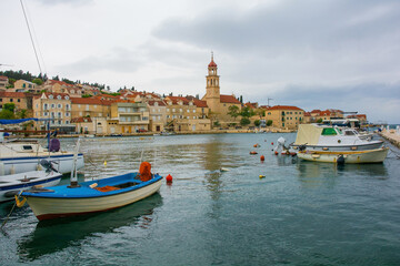 The harbour of the historic village of Sutivan on Brac Island in Croatia. The Church of the Assumption of the Blessed Virgin Mary is centre