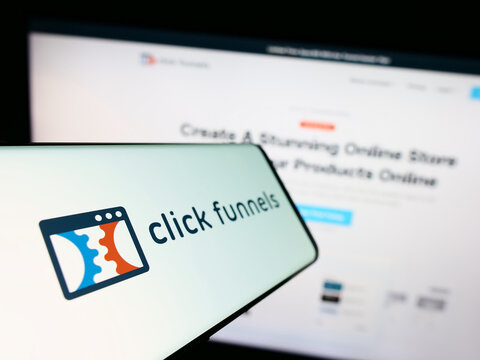 Stuttgart, Germany - 08-17-2023: Mobile phnone with logo of software company ClickFunnels (Etison LLC) on screen in front of website. Focus on center-left of phone display.