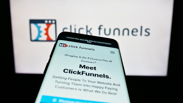 Stuttgart, Germany - 08-17-2023: Smartphone with website of software company ClickFunnels (Etison LLC) on screen in front of business logo. Focus on top-left of phone display.