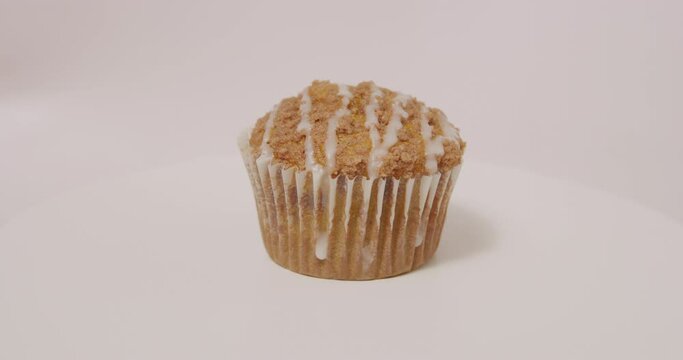 Pumpkin Spice muffin spinning on turntable on white background