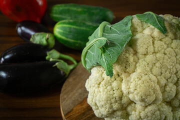Whole head of the fresh raw cauliflower with some leaves
