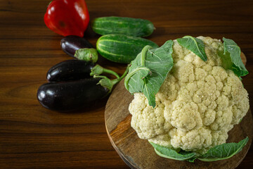 Whole head of the fresh raw cauliflower with some leaves