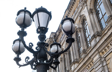 Vintage lanterns on a pole against the background of the building.