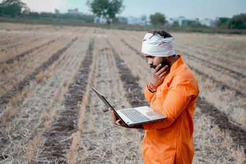 Young indian farmer in depression after see some detail in laptop.
