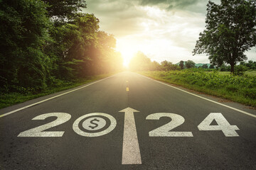 New year 2024 and business performance target concept. Dollar money symbol and text 2024 written on the road at sunset. Concept of planning, challenge, business strategy, opportunities, performance.