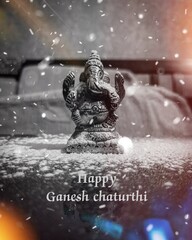 Lord ganesh statue with Happy ganesh chaturthi text on foreground