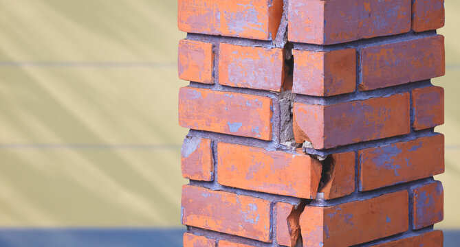 Crack line texture on the old damaged rectangle brick column outside of house, close up shot and perspective view with copy space
