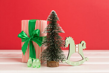 Miniature christmas tree with gift boxes and decor on table