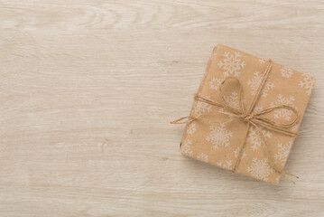 Craft christmas gift boxes on wooden background, top view
