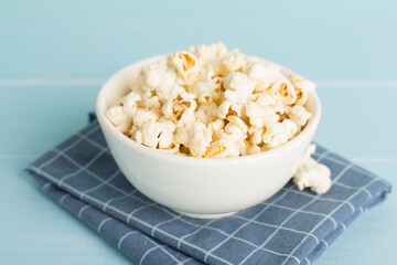 Prepared popcorn in bowl on wooden table