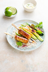 Delicious Asian-style chicken kebabs with rice, vegetables and teriyaki sauce.