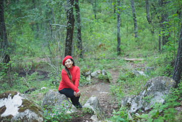Naklejka na ściany i meble Woman with a positive attitude admiring the forest.