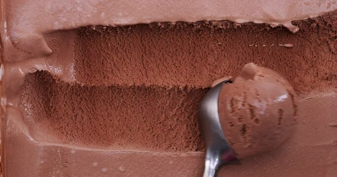Close-up 4K footage top view, Use a spoon to scoop the chocolate ice cream.