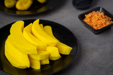 Seasonal pickled fruits on a plate with dipping sauce