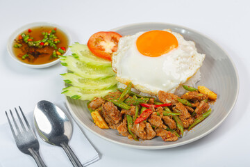 Beef Panang Curry. Thai food. Coconut milk curry and fried egg with rice on white background.