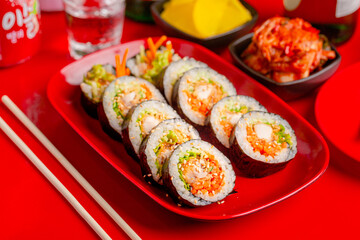 Fried chicken kimbap with Korean seaweed rice on a red plate