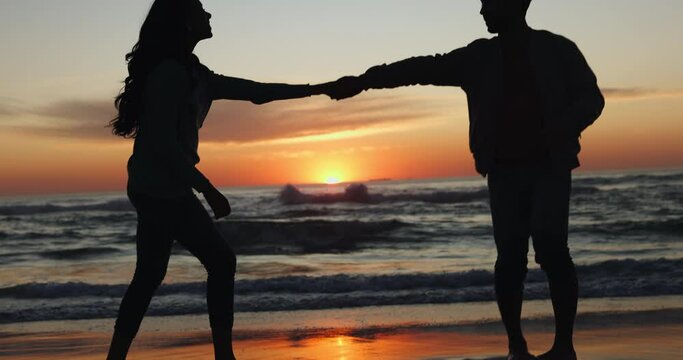 Silhouette, dancing and couple on sunset beach on vacation or tropical holiday together for love or care. Celebration, man and woman with happiness on anniversary with travel freedom at ocean