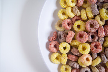 Cereal for breakfast is served on a white plate with a white background