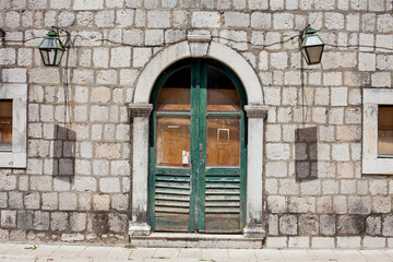 Fototapeta na wymiar Old stone building texture background street view door