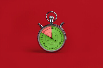 stopwatch with colorful segments on red background. Interest-free period concept