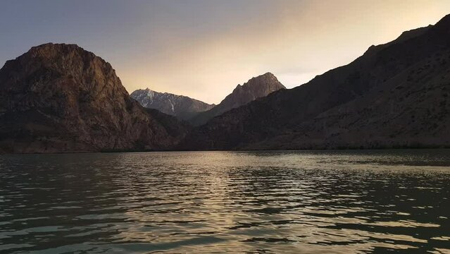 Iskanderkul Lake Glacial Water, Sughd Province, Tajikistan, Asia With Sunset Above Mountain Peaks